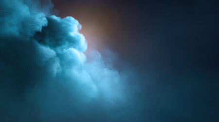 Captivating blue smoke cloud emerges from a dark background, creating a serene atmosphere. Ideal for artistic projects, wallpapers, or calming visuals.の素材