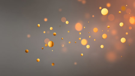 This stunning abstract image showcases shimmering golden and orange bokeh circles against a smooth gray backdrop, creating a warm and elegant atmosphere ideal for design applications.の素材