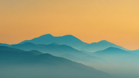 A tranquil view of rolling mountains captures the serene beauty of dusk. The soft orange and blue hues blend harmoniously, creating a peaceful atmosphere.の素材