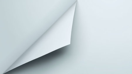 This image features a softly curled edge of a light gray paper sheet on a minimalist background, creating an elegant visual contrast perfect for design and creativity.の素材