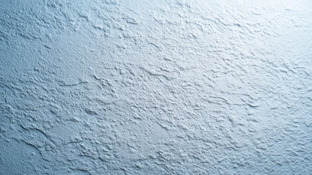A beautifully textured wall surface featuring subtle blue tones, perfect for artistic backgrounds or minimalistic design projects that require a touch of elegance.の素材