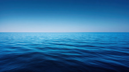 This image showcases a vast expanse of the ocean under a clear blue sky. The gentle waves create a soothing atmosphere, ideal for evoking calmness and tranquility.の素材