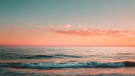 Experience the tranquility of a serene ocean sunset at dusk, where gentle waves meet a vibrant horizon filled with soft pastel colors and a calming atmosphere.の素材