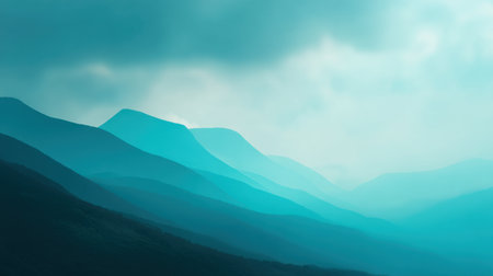 Serene mountain landscape enveloped in mist, showcasing soft blue and green tones under gentle clouds. Ideal for nature-themed projects and peaceful backgrounds.の素材