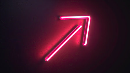 Glowing pink neon directional arrow icon, bright on dark backgroundの素材
