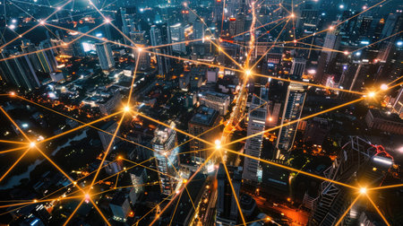 Modern city at night with interconnected network, telecommunication and connectivity, top viewの素材