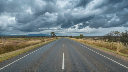 Straight road on Matilda Highway under overcast skies in Queenslandの素材