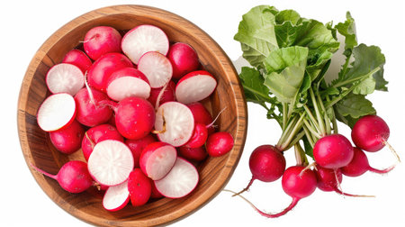 Top view of wooden bowl filled with fresh red radishes and sliced radishes, isolated on whiteの素材