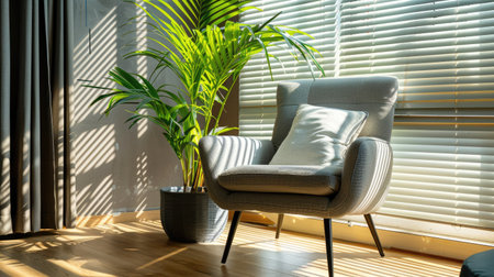 Comfortable soft armchair and houseplant by large window with blinds, spacious room designの素材