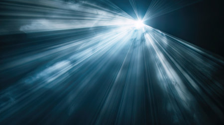 Radiant light beam piercing through darkness, close-up on blackの素材
