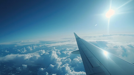 Aerial view from an airplane wing, clouds below, and the Earth's curve visible, capturing a high-altitude perspective from spaceの素材