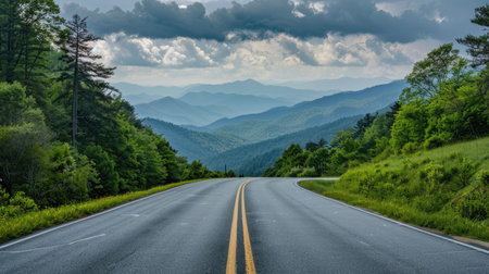 Expansive road heading towards the Great Smoky Mountains National Park, Tennessee, surrounded by lush landscapes and distant peaksの素材
