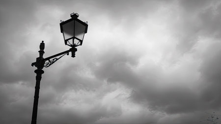 Classic iron lamp post with overcast sky, grey clouds filling the skyの素材