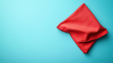 Flat lay of a red kitchen napkin on a clear table surface, highlighting its bright color and providing space for design or textの素材