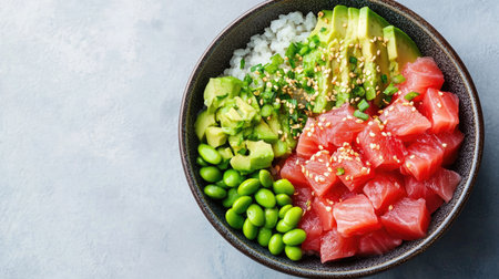 A colorful poke bowl with fresh tuna, avocado, rice, and edamame beans, top viewの素材