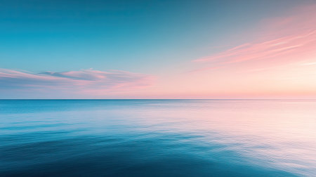 A serene sea view at twilight, with blue waters and a soft pink sky.の素材