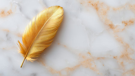 This stunning image features a delicate golden feather resting on a luxurious marble surface, perfect for inspiring modern and elegant designs.の素材