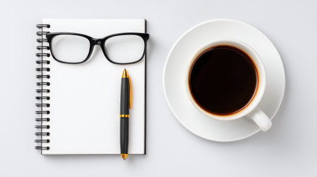 A stylish flat lay arrangement featuring a notebook, a pen, glasses, and a cup of black coffee on a clean background, symbolizing productivity and creativity.の素材