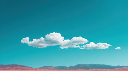 A breathtaking view of a serene desert landscape featuring a turquoise sky dotted with fluffy clouds over a majestic mountain range. Perfect for nature lovers.の素材