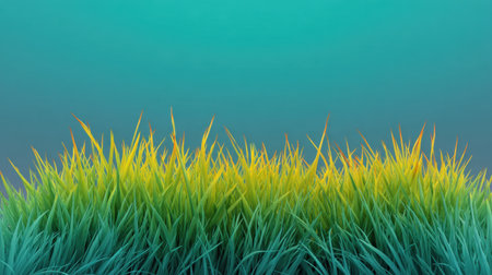Captivating image of vibrant grass with a gradient blend of green and yellow against a soft blue background, perfect for nature and landscape themes or artistic projects.の素材