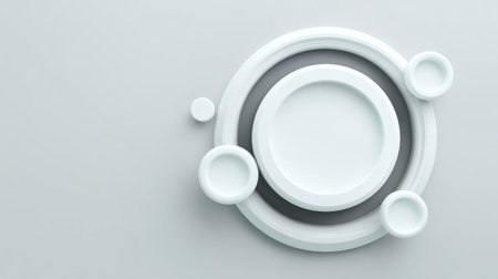 Minimalist display of white plates and bowls on a soft gray surface, emphasizing clean lines and elegant shapes ideal for culinary presentations and decor.の素材