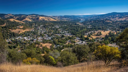 Experience the breathtaking beauty of a lush green valley framed by rolling hills under a vibrant blue sky. This serene landscape captures the essence of nature's tranquility.の素材