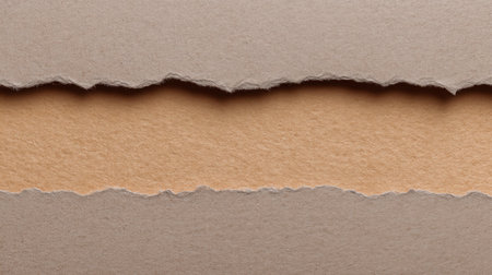 A close-up image of torn paper showcasing a soft beige layer between two textured brown sheets. Ideal for artistic backgrounds or creative design projects.の素材