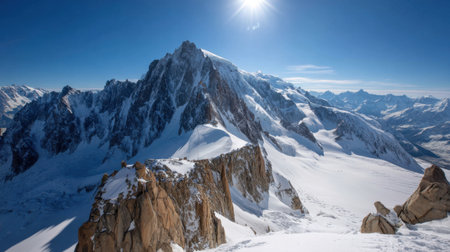 Breathtaking view of majestic snow-covered mountain peaks under a clear blue sky, with bright sunlight illuminating the alpine landscape, showcasing natureの素材