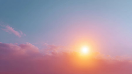 A breathtaking view of a sunrise with soft pink and orange colors illuminating the sky and clouds, creating a tranquil scene perfect for inspiration and relaxation.の素材