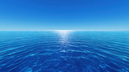 A stunning view of an expansive blue ocean meeting a bright clear sky. Gentle waves reflect the sunlight, creating a serene atmosphere perfect for relaxation.の素材