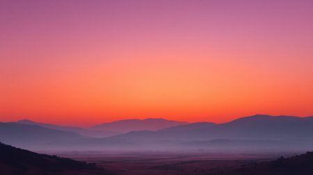 Experience a breathtaking view of a majestic sunrise illuminating misty mountains. The soft hues of dawn create a peaceful and serene atmosphere in the landscape.の素材