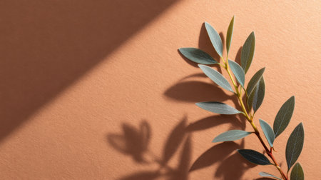 A delicate green leaf branch elegantly rests on a warm earth-toned background, casting refined shadows that enhance the minimalist aesthetic and natural beauty.の素材