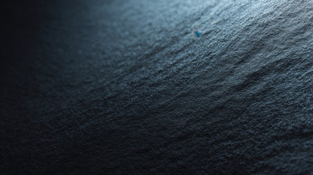 This close-up image captures the intricate texture of dark ocean waves, highlighting natural patterns and the subtle interplay of light and shadow, perfect for creative uses.の素材