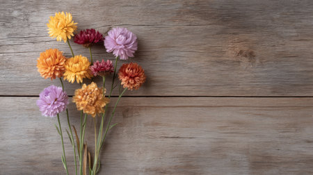 A stunning arrangement of colorful flowers on a rustic wooden background adds a touch of nature and beauty, perfect for decor, art projects, or floral designs.の素材
