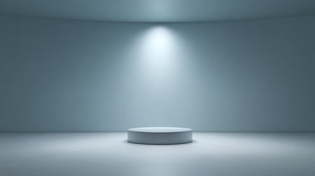 A modern minimalist studio space featuring a round pedestal illuminated by a focused spotlight, perfect for exhibitions, presentations, or artistic displays in a serene blue setting.の素材