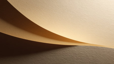 This image showcases the gentle curves of beige paper illuminated by soft natural light, creating a harmonious interplay of textures and graceful shadows. Perfect for artistic themes.の素材