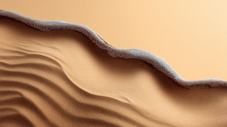 An artistic and serene close-up image showcasing the smooth transition of sand and waves, perfect for evoking a sense of calm and natural beauty in design.の素材