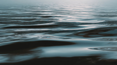 A stunning close-up of calm water gently reflecting light, showcasing the tranquil ripples and serene atmosphere that evoke a sense of peace and relaxation.の素材