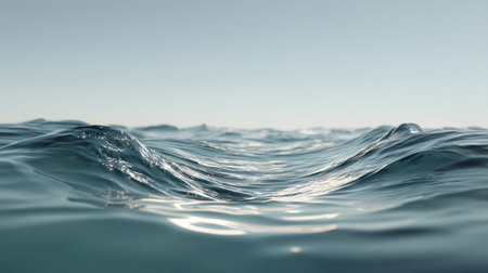 Explore the beauty of calm ocean waves under a clear blue sky. Gentle reflections dance on the waterの素材