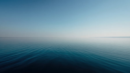 Experience the serene beauty of a calm ocean surface meeting a clear blue sky, creating a peaceful ambiance perfect for relaxation and meditation in nature.の素材