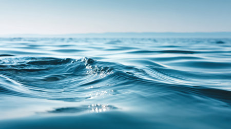 A tranquil ocean surface showcasing gentle waves glistening under soft sunlight, creating a serene and calming atmosphere for nature lovers or travel enthusiasts.の素材