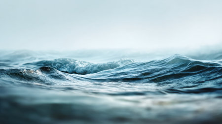 A calming view of ocean waves gently rolling under soft light, enveloped in a delicate mist. This image encapsulates the peaceful essence of nature's beauty and tranquility.の素材