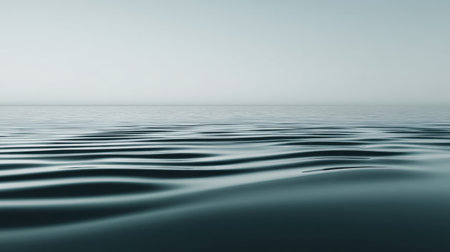 Experience the beauty of a tranquil water surface exhibiting gentle ripples, set in a minimalistic environment that evokes peace and relaxation. Ideal for calming visuals.の素材
