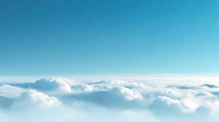 A breathtaking view of a clear blue sky above a blanket of fluffy white clouds, capturing the peaceful essence of nature in a serene and tranquil atmosphere.の素材