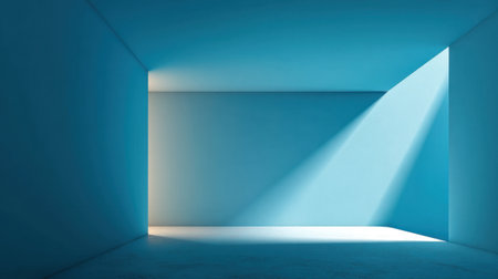 This minimalistic blue room showcases soft shadows and natural light, creating an elegant atmosphere ideal for artistic projects and creative compositions.の素材