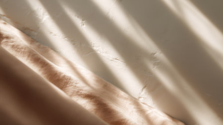 A beautiful composition featuring soft fabric draped elegantly, illuminated by gentle light and showcasing a textured wall. Ideal for cozy and stylish home decor inspiration.の素材