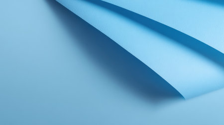 Captivating light blue paper gently curves, forming an elegant texture that enhances any creative project. Perfect for backgrounds, stationery, and modern designs.の素材