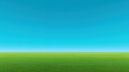 This stunning image captures a vibrant green grass field stretching toward a clear blue sky, creating a peaceful and serene atmosphere perfect for outdoor themes.の素材