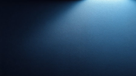 This image showcases a soft blue light casting gentle illumination on a textured dark wall, creating a serene background perfect for minimalist design and artistic projects.の素材