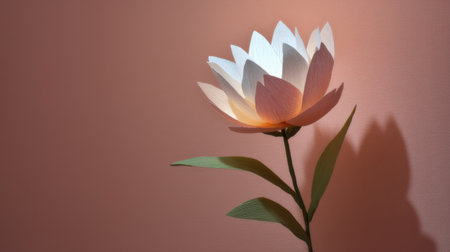 This beautiful paper flower showcases intricate design and soft illumination against a pastel pink backdrop, perfect for enhancing creative spaces and decor.の素材